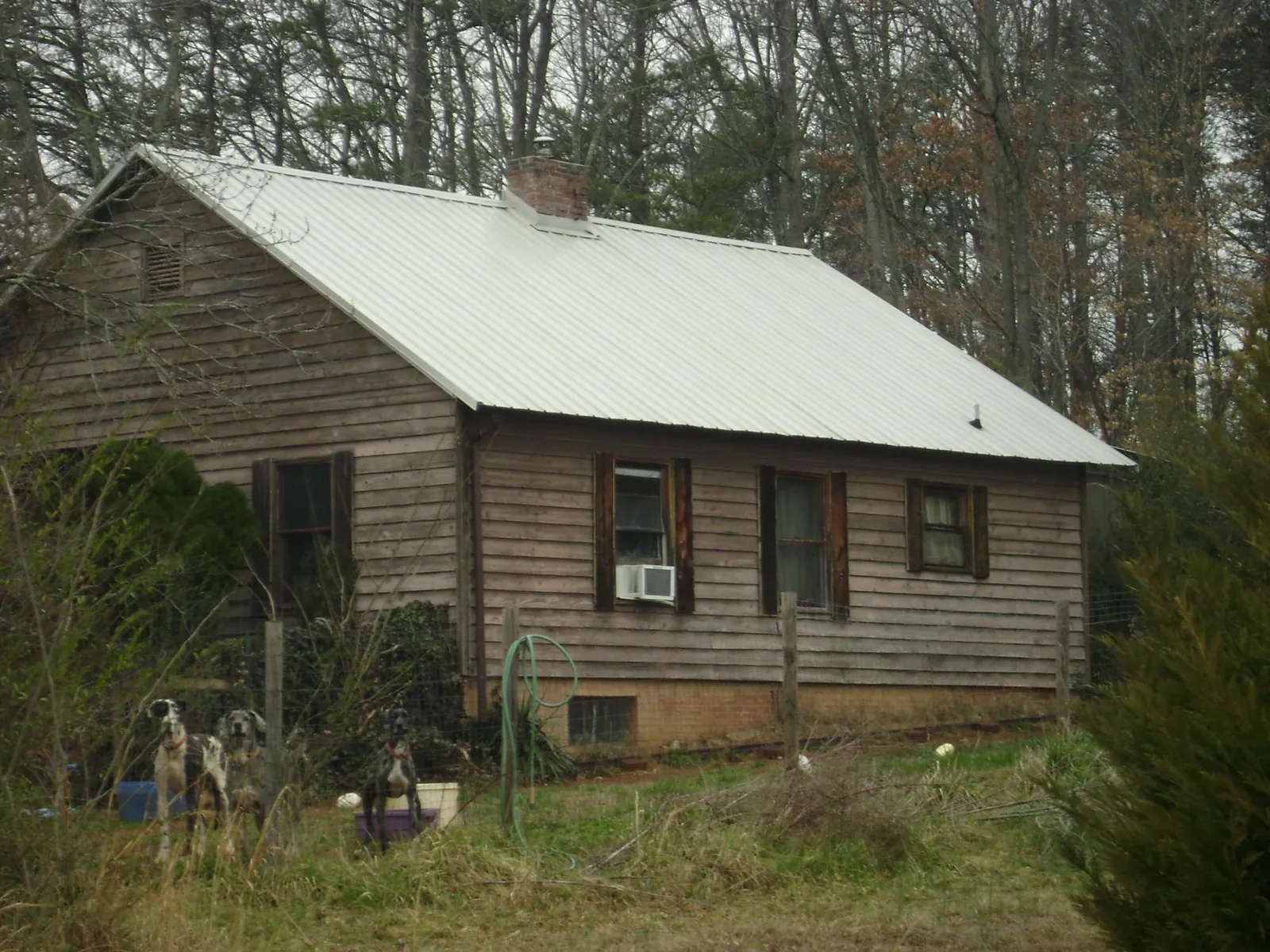 White metal roof on an old wood sided farmhouse, from a Metal Roof Installation job in Newtown